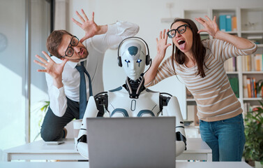 Office workers mocking their robot colleague