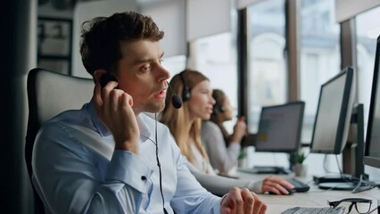 Call operator listening client in office. Friendly helpline team work together.