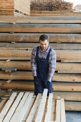 Joiner in uniform check boards on timber mill