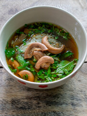 Rice Noodles Beef Soup with Beef Intestine Braised ontop Garlic and Stink Weed decorate Spring onions and Basil Thai herbs. Thai Boat Noodles Style topview