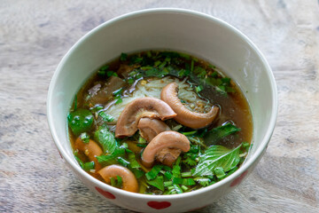 Rice Noodles Beef Soup with Beef Intestine Braised ontop Garlic and Stink Weed decorate Spring onions and Basil Thai herbs. Thai Boat Noodles Style topview