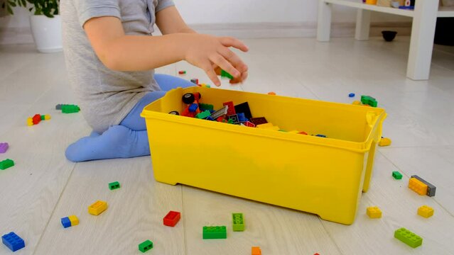 Constructor child plays in the room. Selective focus. Kid.