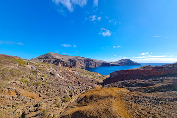Dark red island rocks in the ocean.