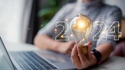 2024 creative concept, women holding light bulb 2024 numbers, 2024 number for creative thinking...