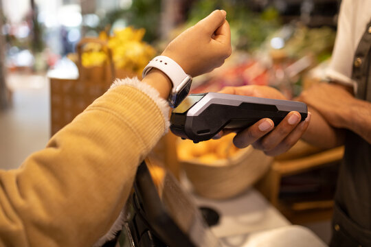 Unrecognizable woman with smartwatch making electronic payment