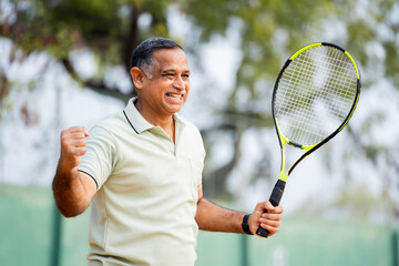 Angry indian senior men after losing the game while playing tennis at court - concept of...