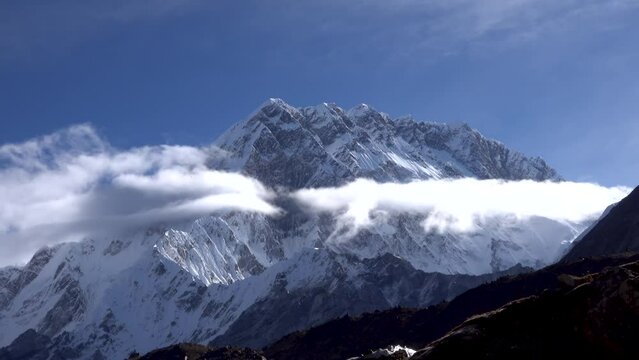 Lhotse Himalaya mountain with clouds and clear blue sky
Wide shot from Himalaya mountain, 2023 
