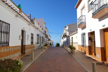Street with white houses  in a traditional Andalusian village in southern Spain