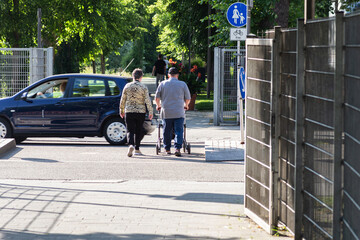 senior couple with rollator in park