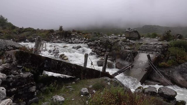 Fallen collapsed bridge in river after earthquake with fog
Slow motion shot from Nepal,2023
