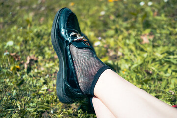 legs in shoes on grass
