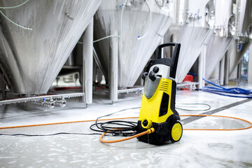 high pressure water cleaner of black and yellow color, put on the floor in warehouse