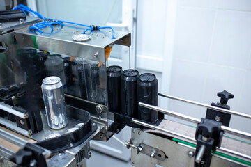 a drink production on the factory, metal cans filled with fresh drink put on the line