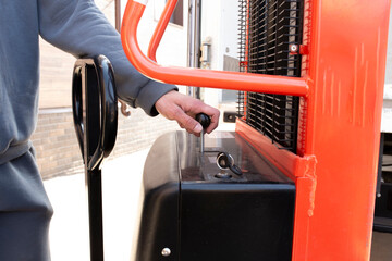 employee using the automatic hydraulic trolley lifter or forklift on the production delivery