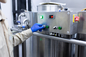 operator employee push the button in the factory production department