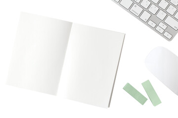 Blank notebook, white keyboard, white mouse, green sticky note