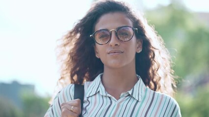 Video of beautiful woman enjoying nature while walking in a park