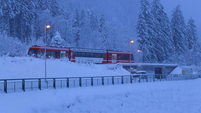 Red Train in snowy mountains  at dusk in Chamonix, France