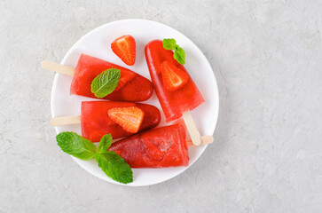 Refreshing Strawberry Popsicles, Ice Lolly with Fresh Strawberry and Mint on Bright Background