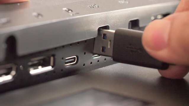 Hand of people try to insert USB to a port
