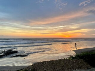 surfers at sunset