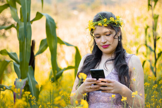 
Foto de una mujer sosteniendo un teléfono celular en la mano en el campo, una linda chica mirando la pantalla del móvil,