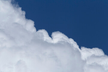 edge of white cloud against clear blue sky
