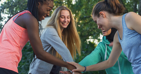Group of Female Teenagers Stacking Their Hands Together as a Team and Ending with a Cheer. Multiethnic Girls Gathered in a Huddle Preparing a Strategy for a Friendly Basketball Match