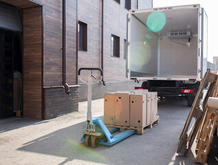 loading some cardbox cargo in the empty white van truck