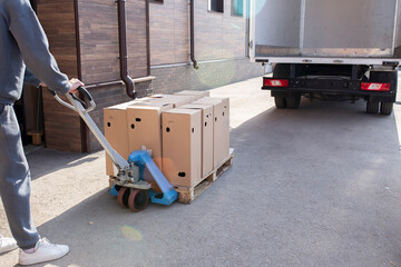 loading some cardbox cargo in the empty white van truck