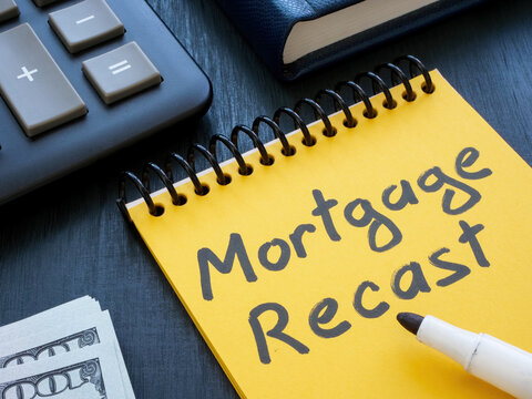 Open notepad with mortgage recast handwritten inscription.