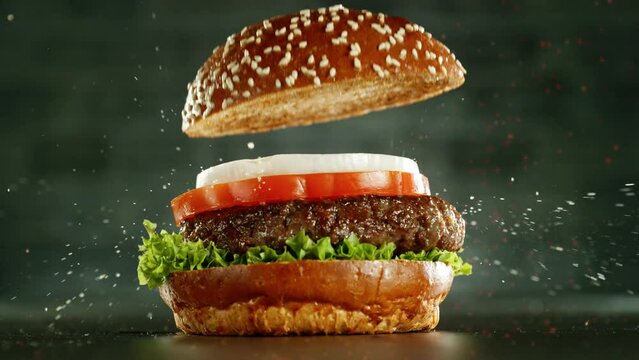 Super slow motion of stacking hamburger pieces. Camera in motion. Filmed on high speed cinema camera, 1000 fps. Placed on high speed cine bot.