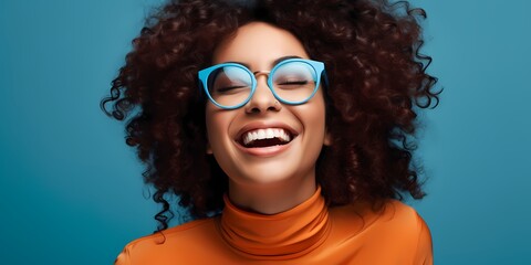 young black woman smiling against a blue background