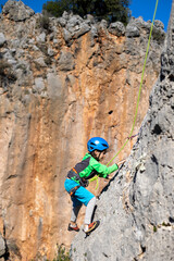 climber boy. the child trains in rock climbing.