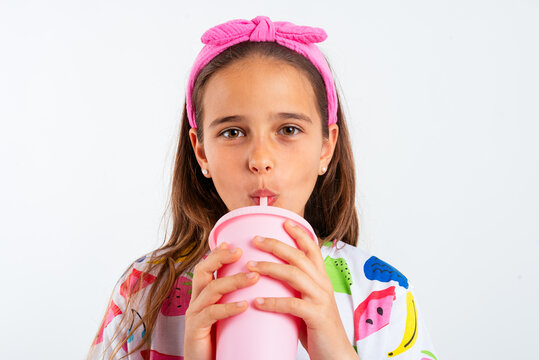 Girl with plastic cup of milkshake