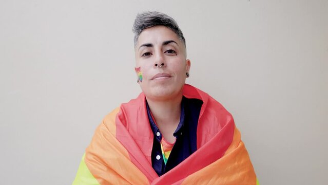 Gay lesbian woman wearing LGBT rainbow flag at pride party event