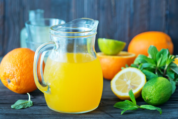 Naklejka na ściany i meble fresh juice in glass dishware and on a table