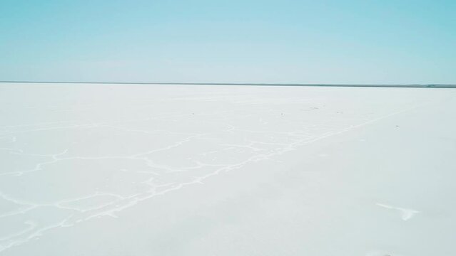 Aerial wide view of salt lake coast. Baskunchak in high tourist season at bright sunny day. Unique lake in the southwest of Russia, medicinal clay and mud deposite