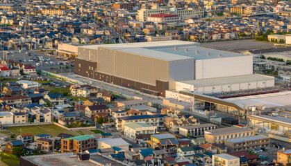 Large industrial warehouse building amid houses in residential neighborhood - 609994635