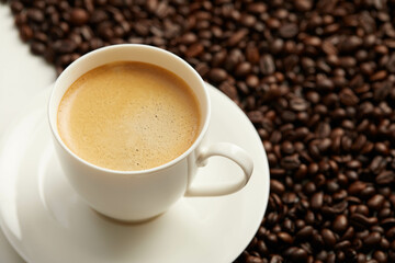 Cup of coffee and coffee beans and spoon,  Isolated on a white background