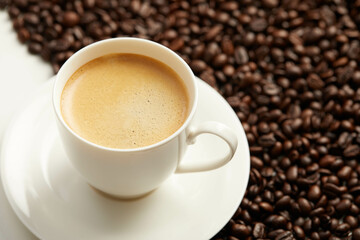Cup of coffee and coffee beans and spoon,  Isolated on a white background