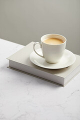 Cup of coffee, on white marble table