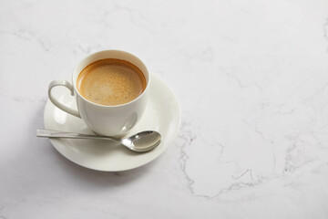 Cup of coffee, on white marble table