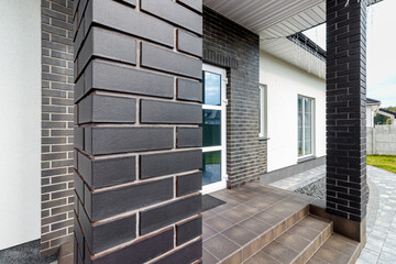 Fragment of a modern building lined with decorative bricks in the old style