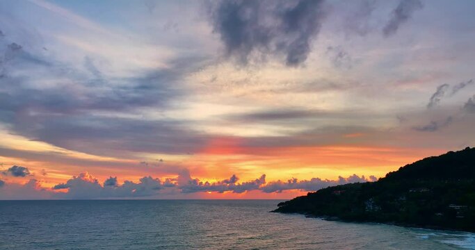 aerial view scenery sunset above the ocean colorful clouds cover the ocean..amazing sky in sunset at Karon beach Phuket Thailand. .Real amazing panoramic sunset sky with gentle colorful clouds..