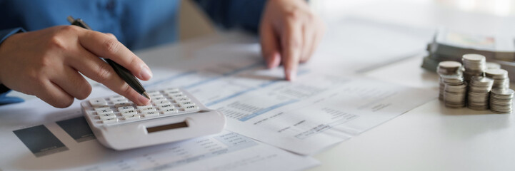 Woman calculating monthly expenses, taxes and interest calculate at home.