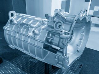The aluminum gear box housing parts in the light blue scene.