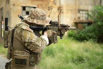 Special forces soldier in camouflage with a pair of weapons that are full of modern technology and complete for battle