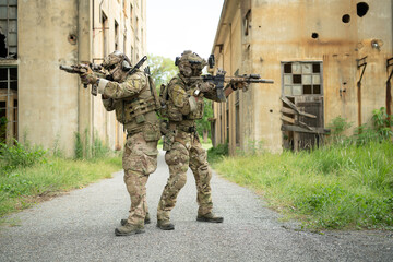 Special forces soldier in camouflage with a pair of weapons that are full of modern technology and complete for battle