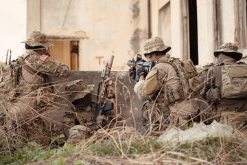 Professional marine soldiers training with weapon on a military range.
